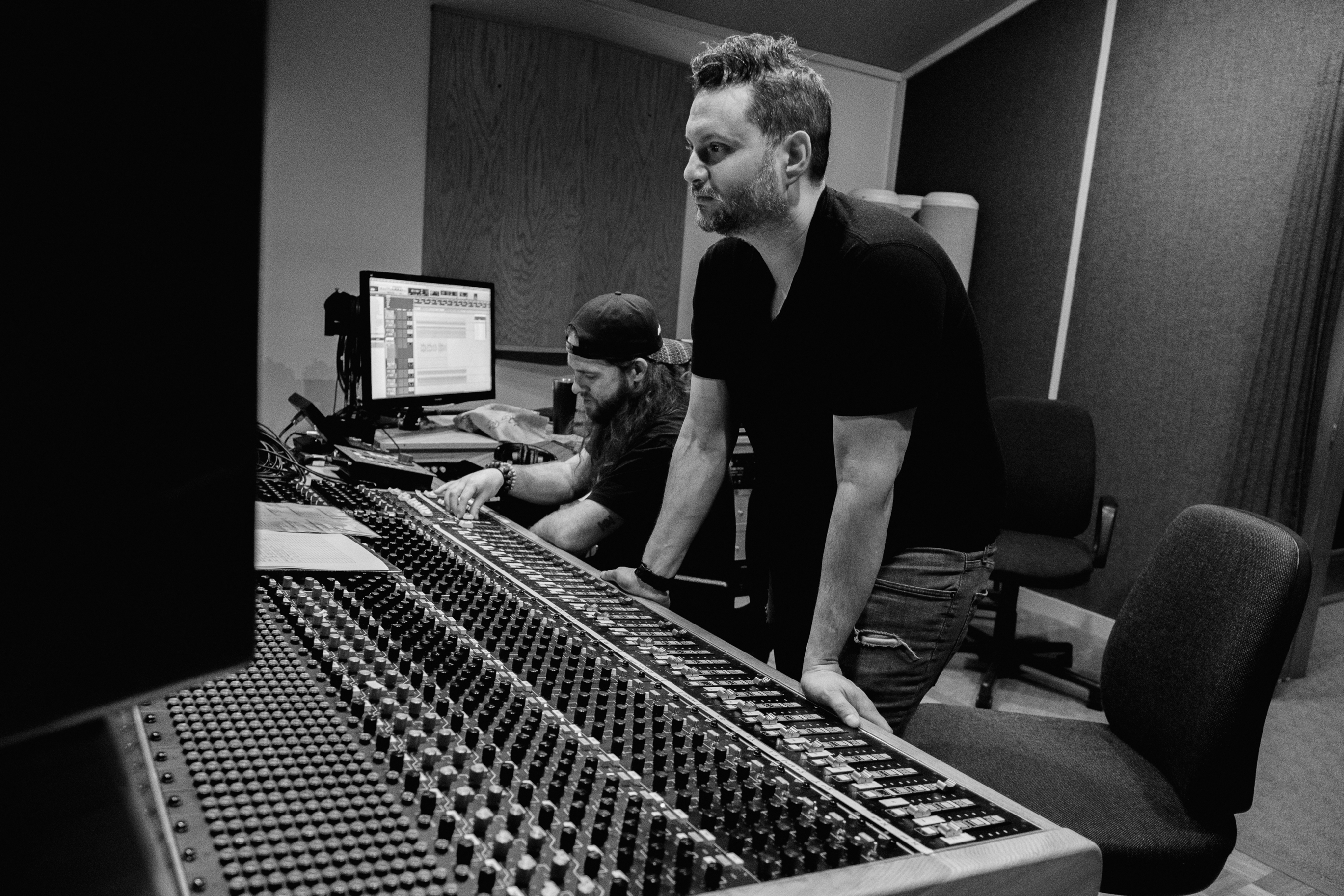 Matt Kass working across a large-format recording console